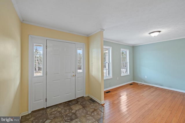 entryway featuring dark hardwood / wood-style flooring, crown molding, and a textured ceiling