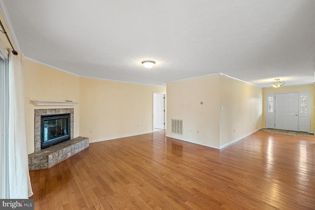 unfurnished living room featuring crown molding and light hardwood / wood-style floors