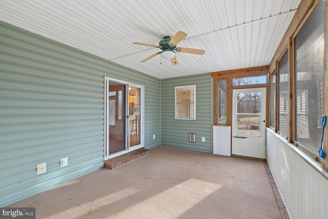 unfurnished sunroom with ceiling fan