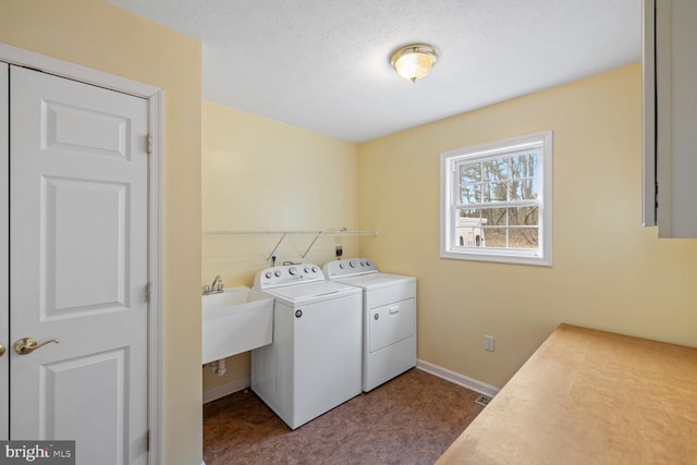 laundry room featuring separate washer and dryer and a textured ceiling