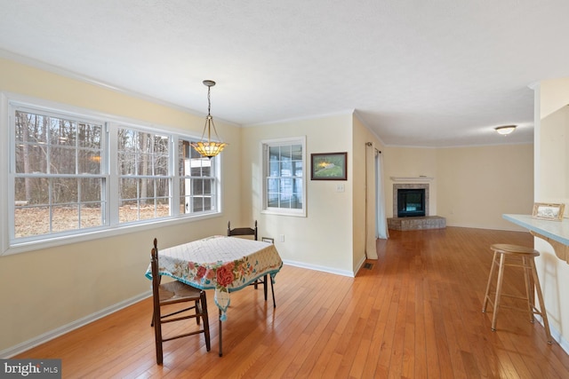 dining room featuring ornamental molding and light wood-type flooring