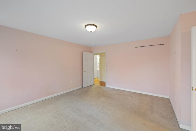 spare room with light colored carpet