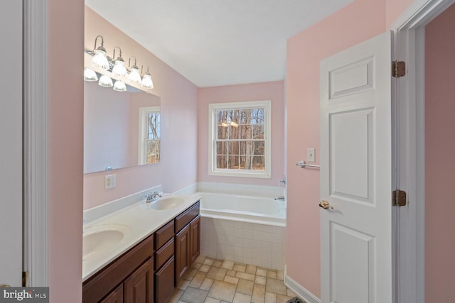 bathroom with vanity and tiled bath