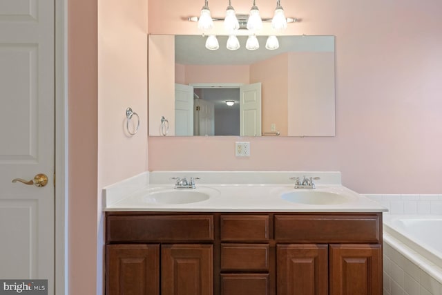 bathroom with vanity and tiled bath