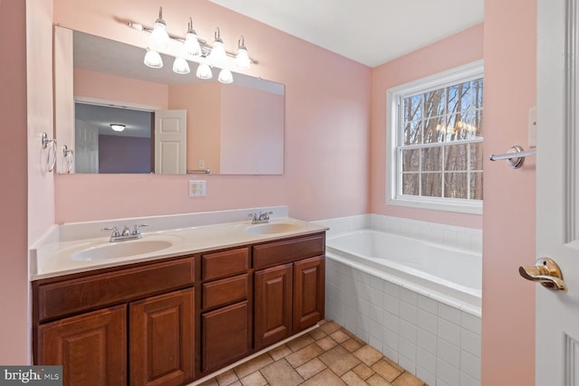 bathroom featuring vanity and tiled tub