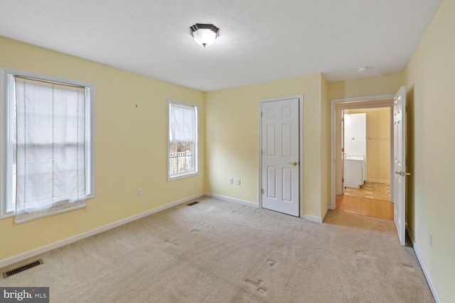 unfurnished bedroom featuring light colored carpet