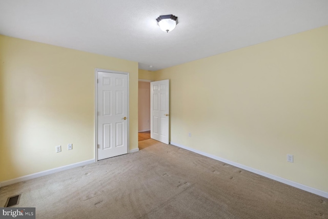 unfurnished room with light colored carpet