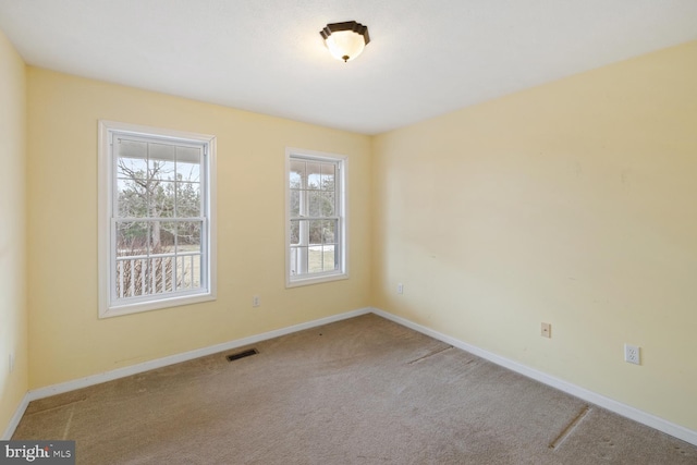 spare room with light colored carpet