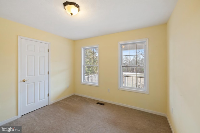 unfurnished room with light carpet