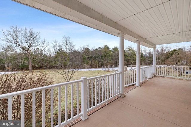 balcony with a water view and covered porch