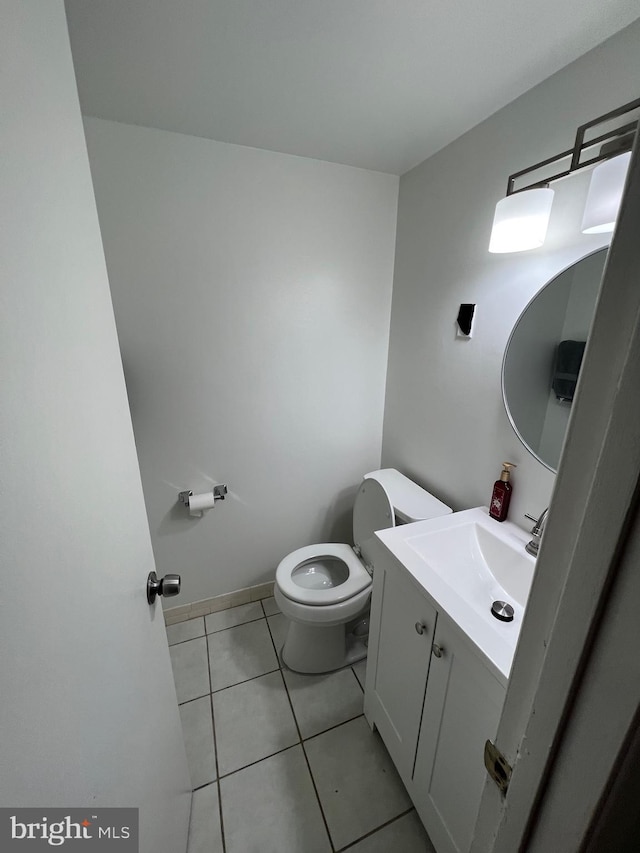 bathroom with tile patterned floors, vanity, and toilet