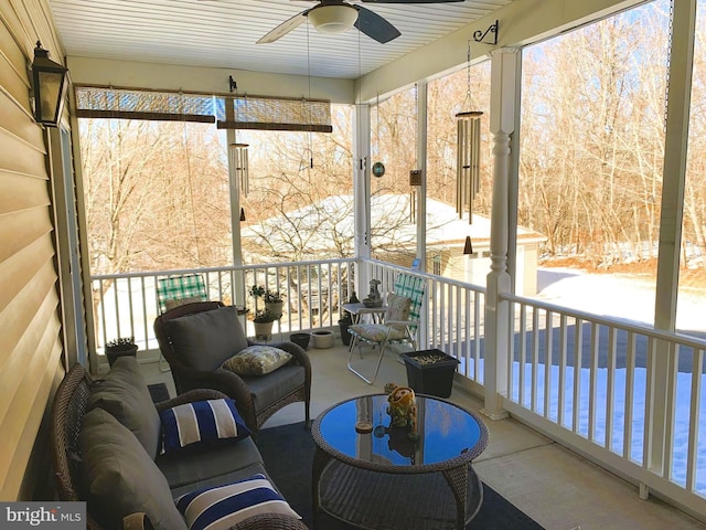 sunroom / solarium with ceiling fan, a healthy amount of sunlight, and a water view