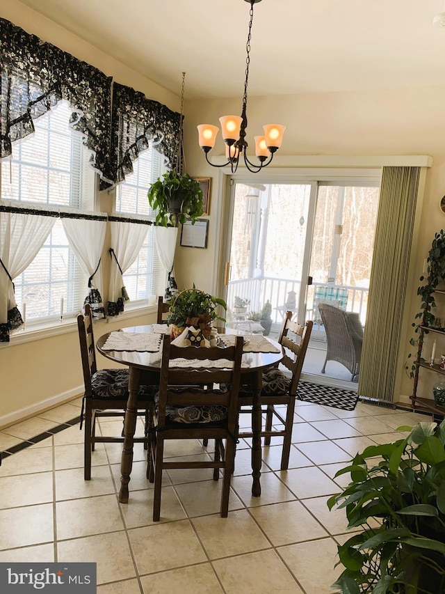 dining area with an inviting chandelier and light tile patterned floors