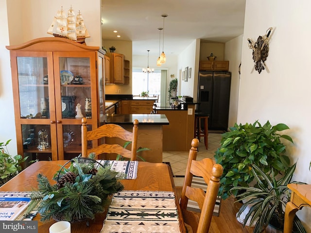 tiled dining space with a notable chandelier