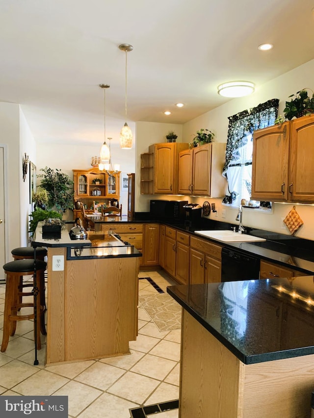 kitchen featuring sink, hanging light fixtures, a center island, and light tile patterned flooring