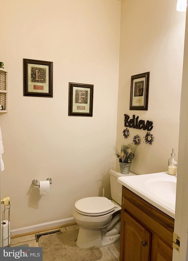 bathroom featuring vanity, tile patterned floors, and toilet