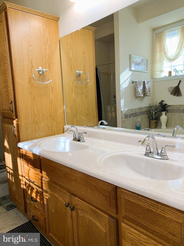 bathroom featuring tile patterned flooring and vanity