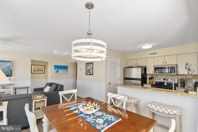 dining area featuring a textured ceiling