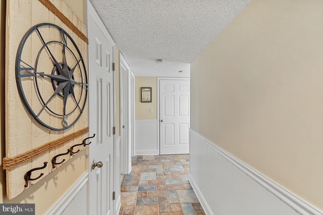 hallway featuring a textured ceiling