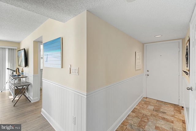 hallway with a textured ceiling