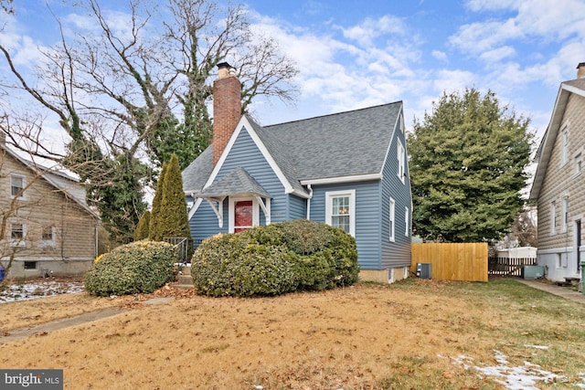 bungalow with a front lawn and cooling unit