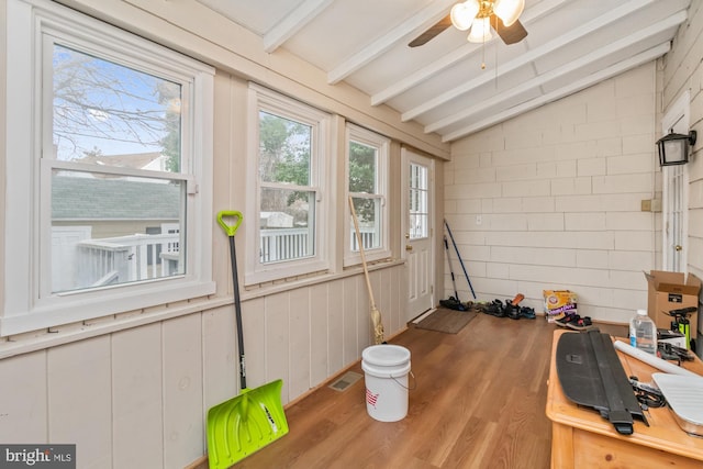 sunroom / solarium with ceiling fan and lofted ceiling with beams