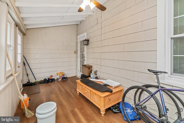 interior space with ceiling fan and lofted ceiling with beams