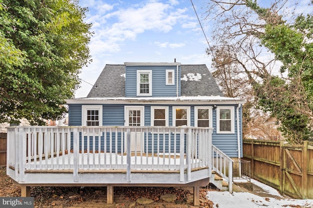 rear view of property featuring a wooden deck