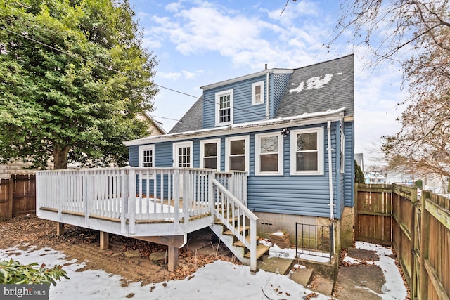 snow covered property with a deck