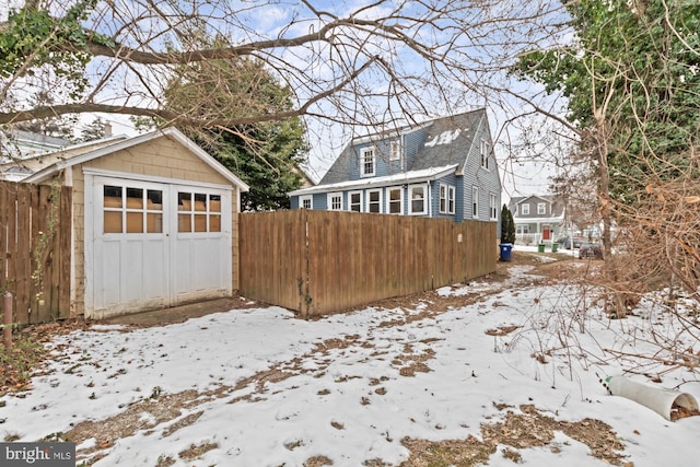 snow covered property featuring a garage