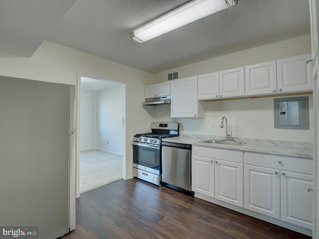 kitchen featuring white cabinetry, sink, stainless steel appliances, dark hardwood / wood-style floors, and a textured ceiling