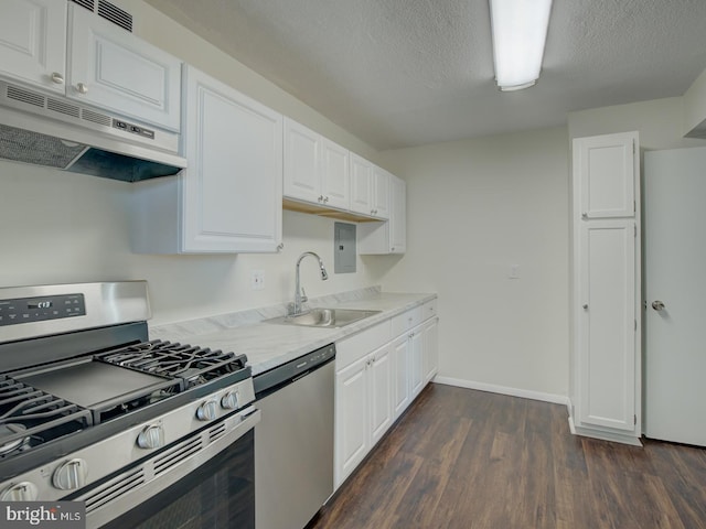 kitchen featuring white cabinetry, sink, dark wood-type flooring, and appliances with stainless steel finishes