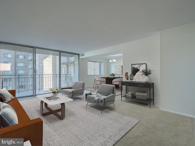 carpeted living room featuring a chandelier