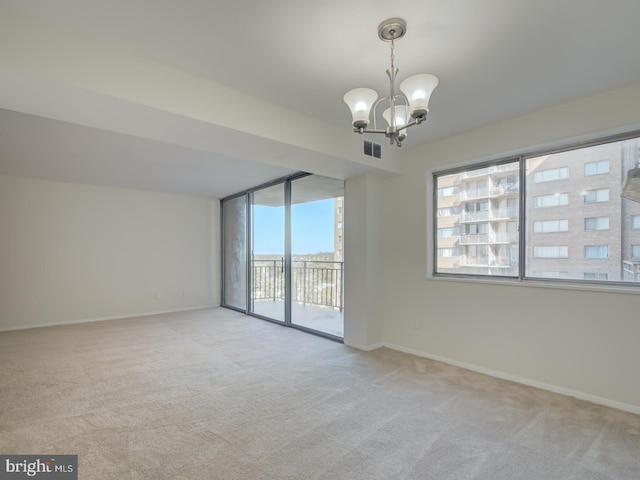 unfurnished room featuring light carpet and an inviting chandelier