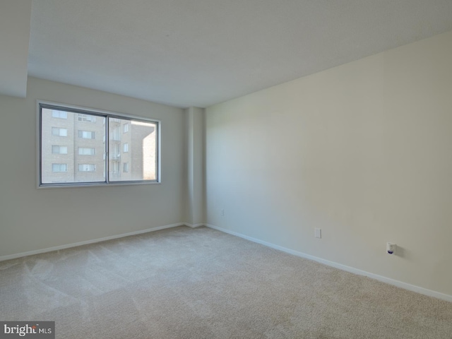 spare room with light colored carpet