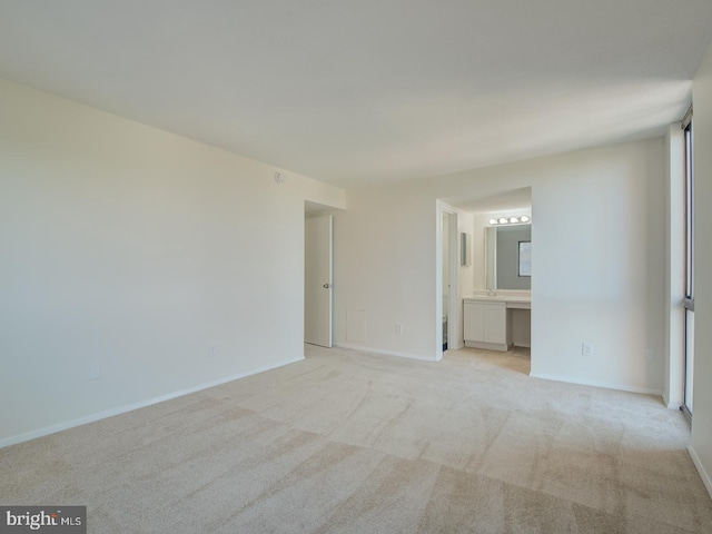 unfurnished room featuring light carpet and plenty of natural light