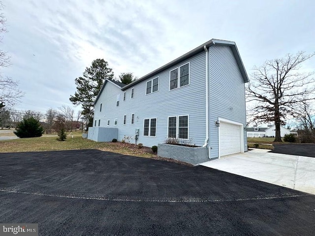 view of side of home with a garage