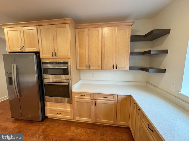 kitchen with stainless steel appliances, dark wood-type flooring, and light brown cabinetry