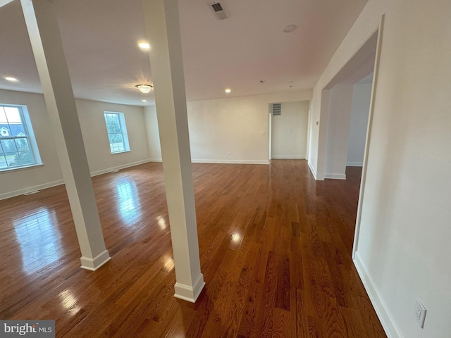 empty room with dark hardwood / wood-style flooring