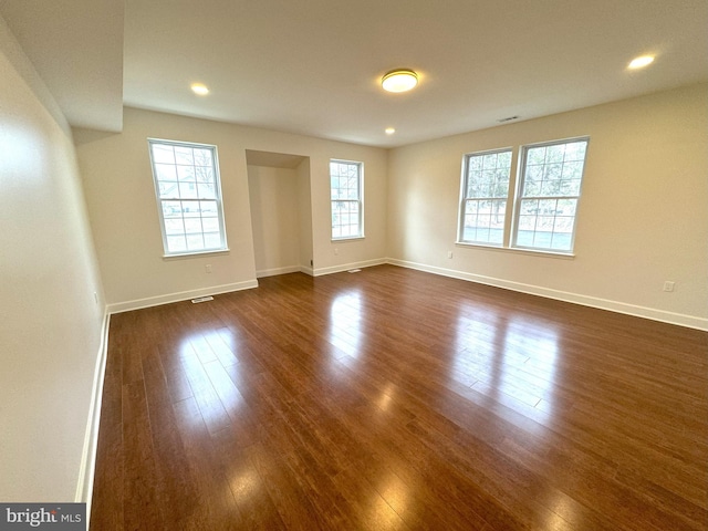 spare room featuring dark wood-type flooring