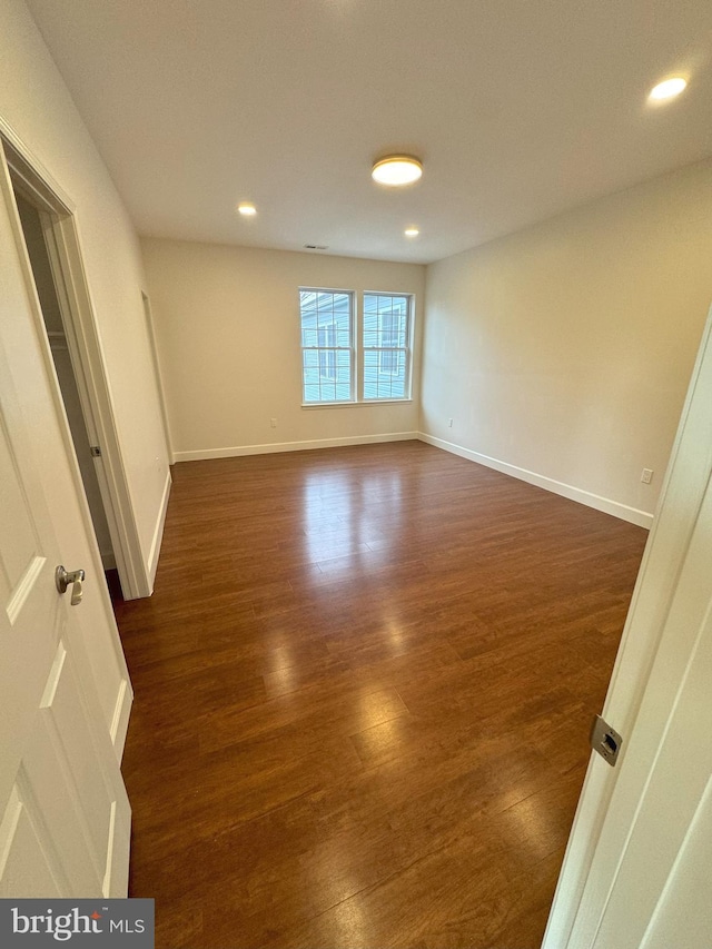 unfurnished room featuring dark hardwood / wood-style floors