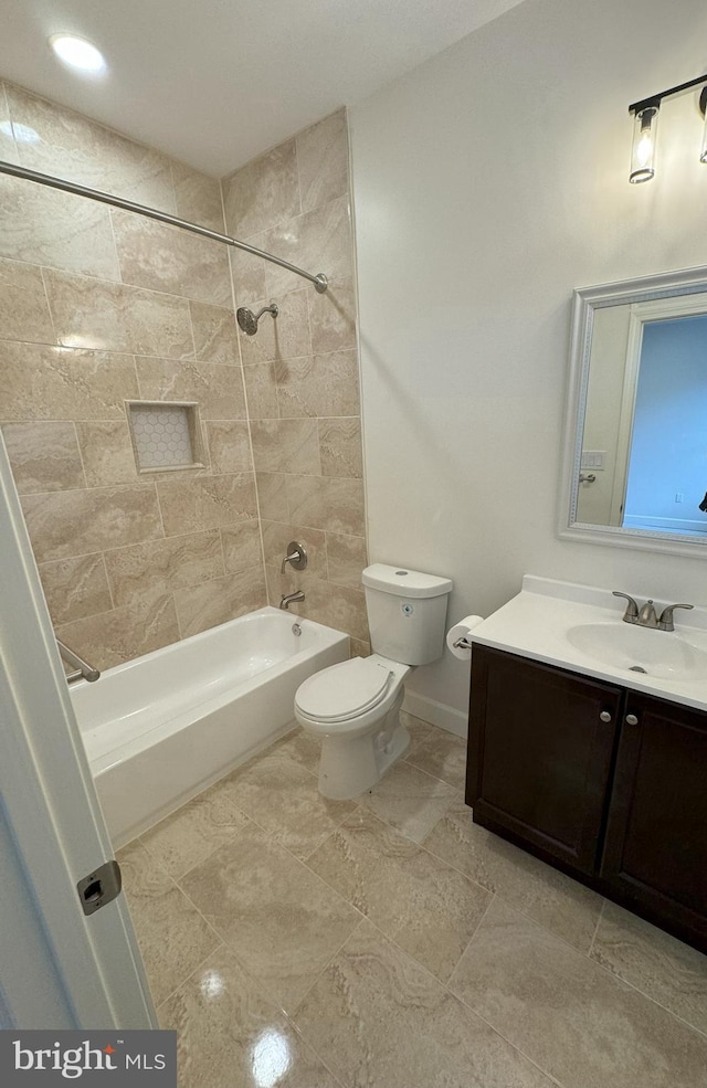 full bathroom featuring vanity, toilet, and tiled shower / bath