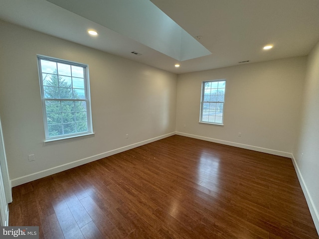 spare room featuring dark hardwood / wood-style flooring