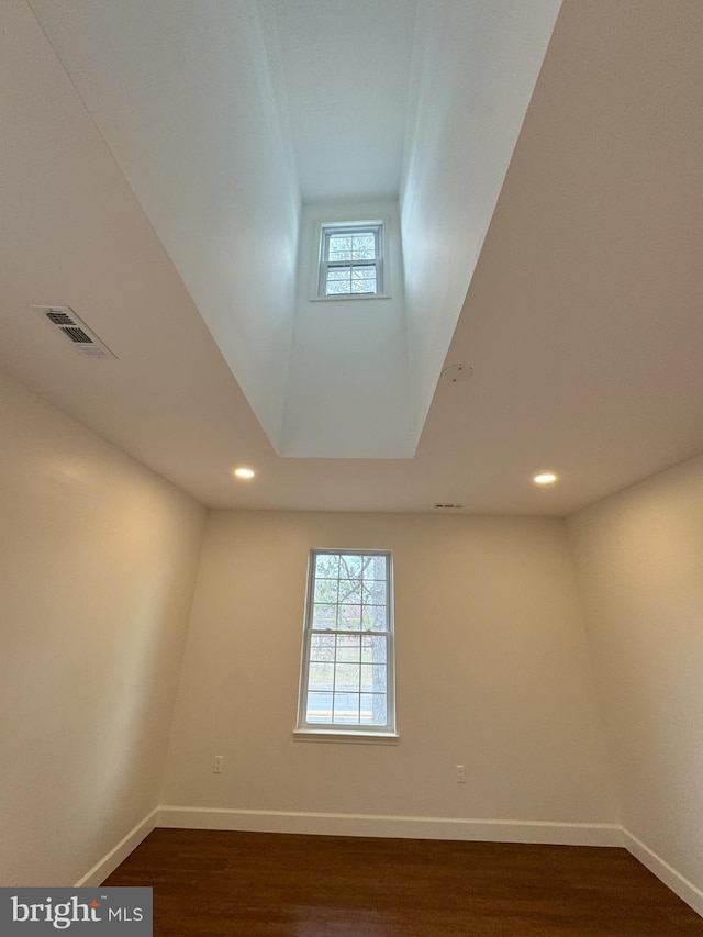 unfurnished room featuring dark hardwood / wood-style flooring