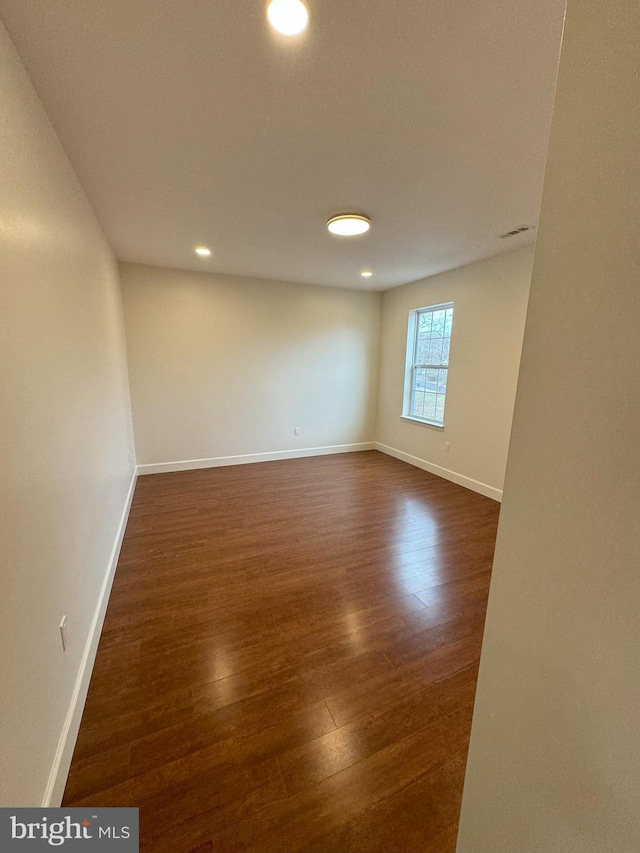 spare room with dark hardwood / wood-style flooring