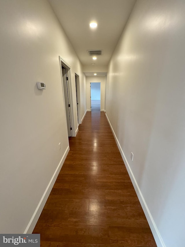 hall with dark wood-type flooring