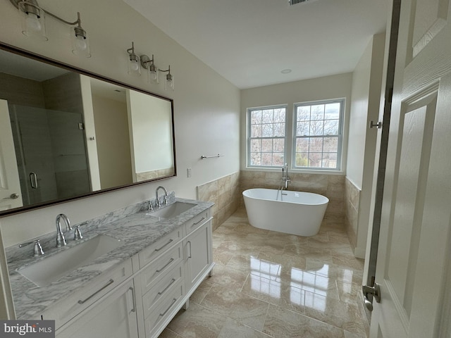 bathroom with tile walls, vanity, and plus walk in shower