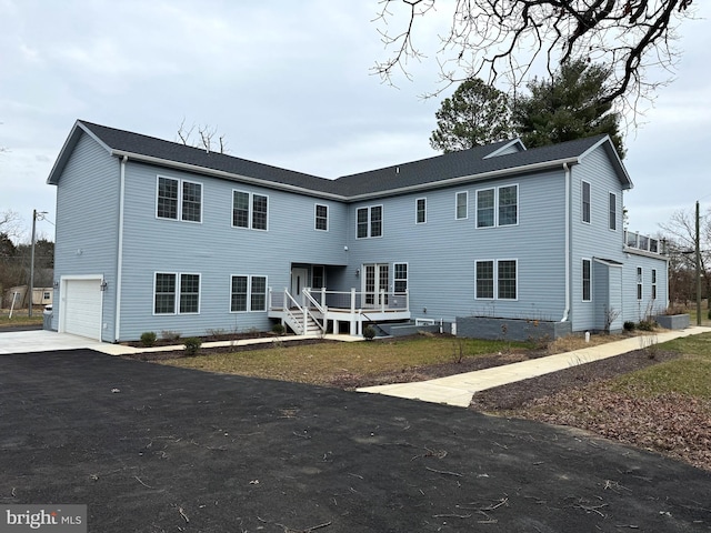 rear view of property featuring a garage