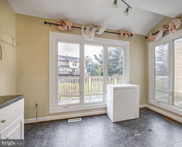 doorway to outside with lofted ceiling