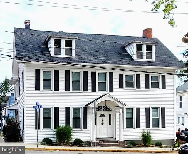 view of front of house featuring a chimney